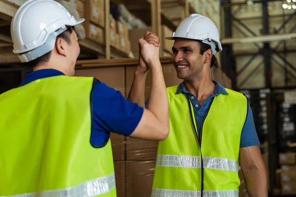 Indian male factory warehouse worker working in logistic industry indoor. Friends greeting and doing handshake with hand grasp in depot — Stock Photo, Image