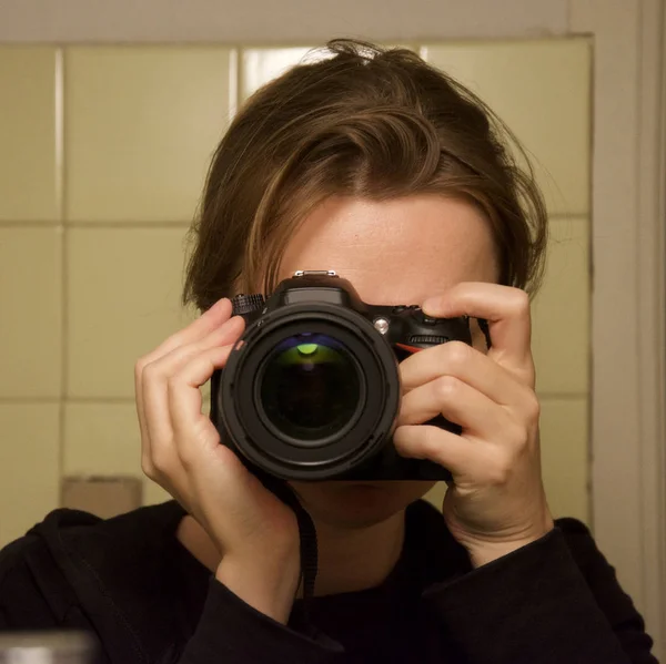 Blonde Woman Holding Professional Camera Taking Selfie Bathroom Mirror Yellow — Stock Photo, Image