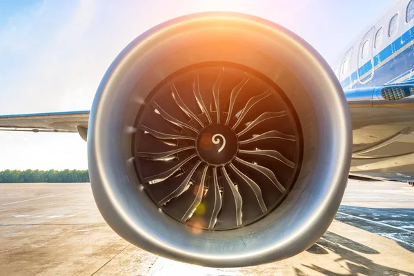 Close up of turbojet of aircraft turbine engine fan civil with a gradient of colors from cold to warm sun glare lights