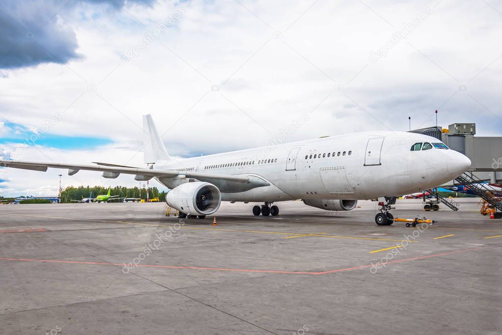 Airplane at the airport in the parking lot before departure gangway