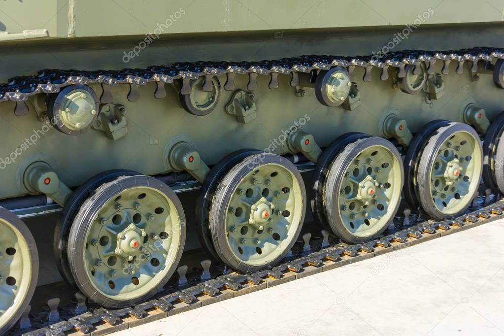 Caterpillar wheels of a tank of green color close-up
