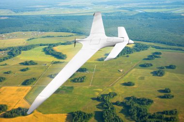 Unmanned military drone on patrol air territory at low altitude clipart