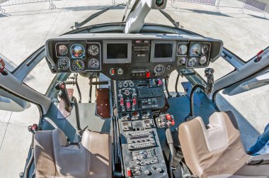Geniş görüş, küçük bir helikopterin kokpiti, kontrol paneli ve direksiyon simidi.