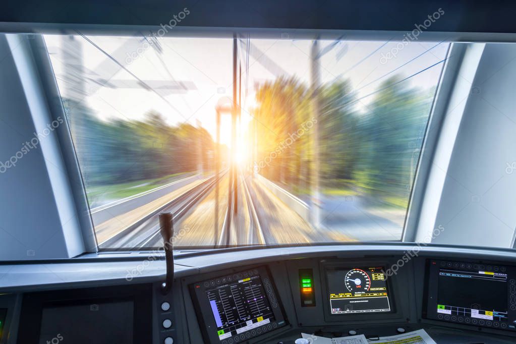 Driver's cab of speed passenger train, view of the railway bridge with the effect of speed motion blur