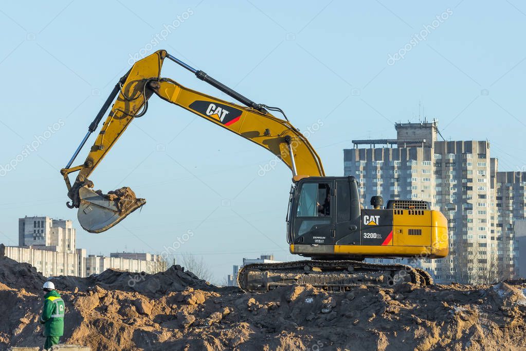 Hydraulic Crawler Excavator Cat working at a ground. Russia. Saint-Petersburg. 16 January 2018