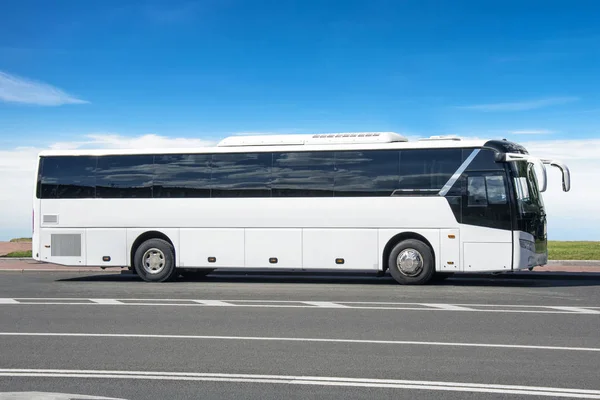 Comfortable white tourist bus on the highway in travel