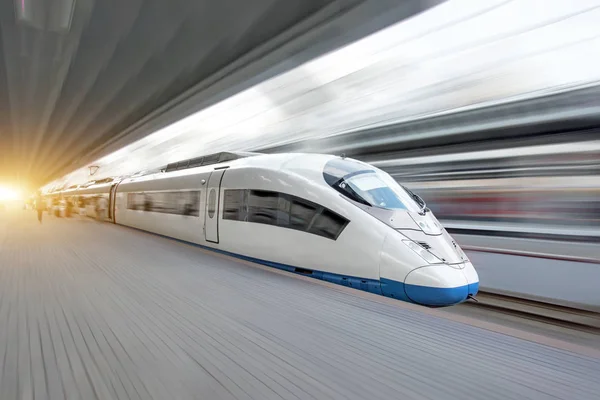 Train rides at high speed at the railway station in the city.