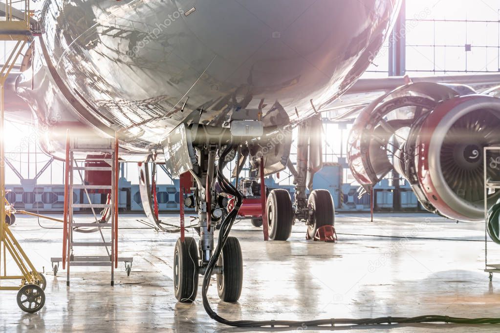 Landing gear and aircraft wheels in hangar, with basic power supply