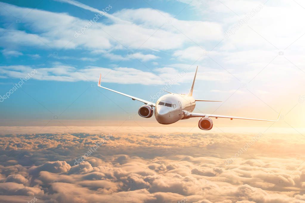 Passenger plane, business trip, travel concept. Flying evening sunset