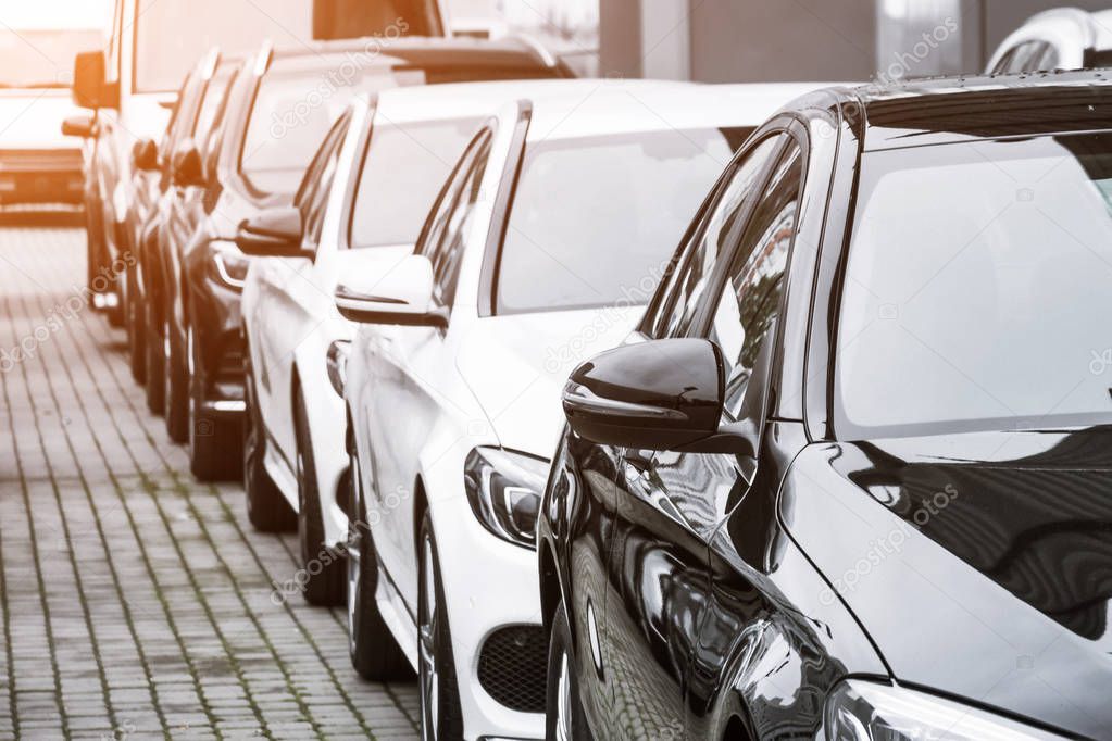 Row of cars, front view on the rear view mirrors