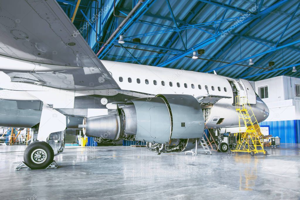 The aircraft is in the aviation hangar. Theme repair and maintenance of airplane airlines