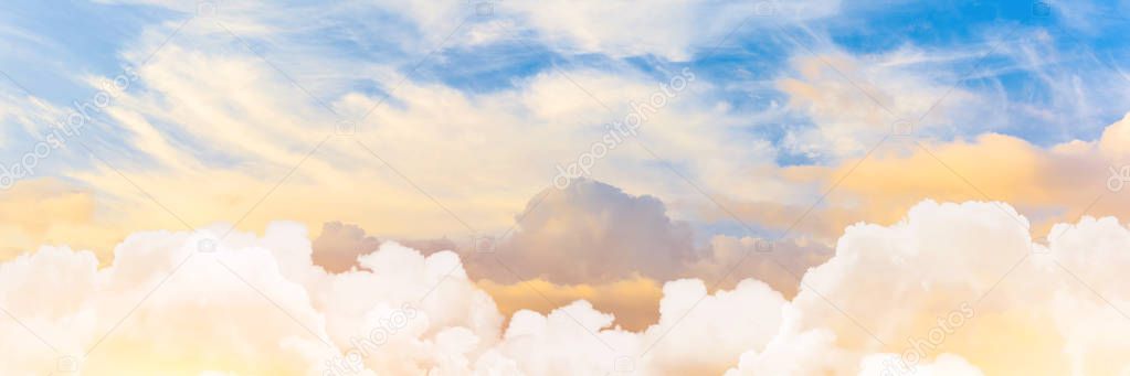 Panoramic shot of sunset sky with cumulus clouds in the foreground and cirrus in height.