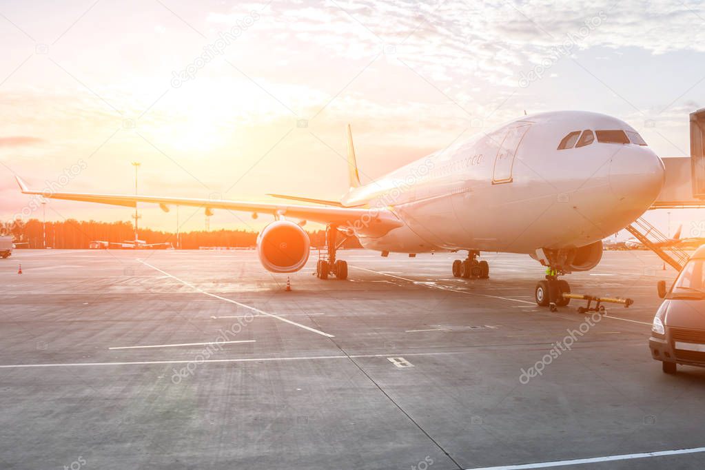 Aircraft in the evening at sunset at the terminal before departure.