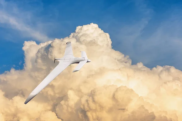 Patrolling unmanned aircraft in the sky against the backdrop of powerful thunderstorm clouds.