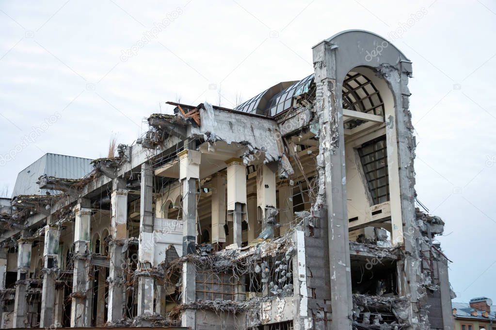 Destroyed building after demolition, man-made accident. The supporting columns, bearing structures are visible. Design construction errors.