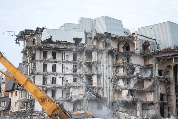 Demolition and destruction of a building using excavator. Destroyers equipment.