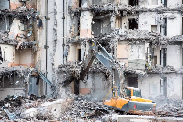 Demolition and destruction of a building using excavator. Destroyers equipment.