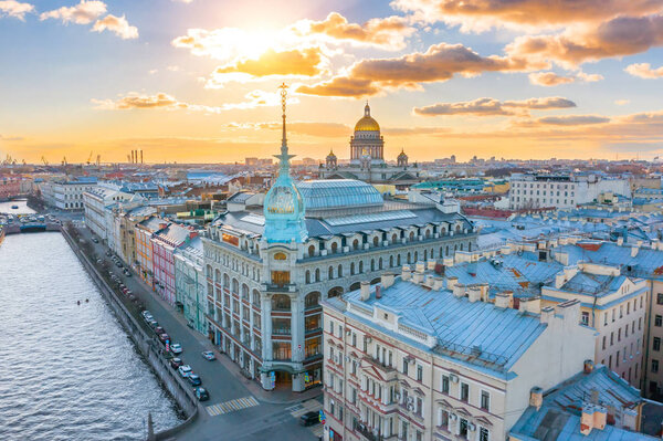 Department store shop class luxury, near the Red Bridge, historical buildings of Saint-Petersburg. In the background the city and St. Isaac's Cathedral dome of golden color, in the evening at sunset.