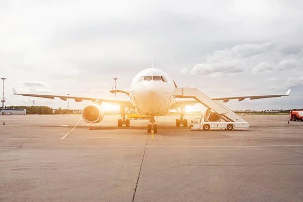 Passenger aircraft, waiting for the passengers to board at the airport terminal.