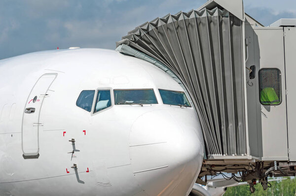 Airplane at the ramp airport terminal, close up view.