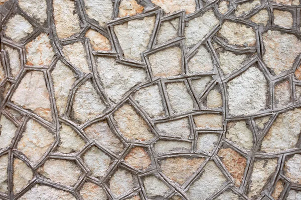 La textura de las baldosas triangulares unidas con cemento en la pared . — Foto de Stock