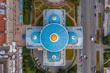 The famous Trinity Cathedral with blue domes and gilded stars, aerial top view of the historic part of the city of Staint-Petersburg, typical houses around. clipart