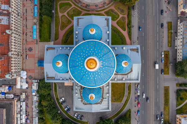 The famous Trinity Cathedral with blue domes and gilded stars, aerial top view of the historic part of the city of Staint-Petersburg, typical houses around.