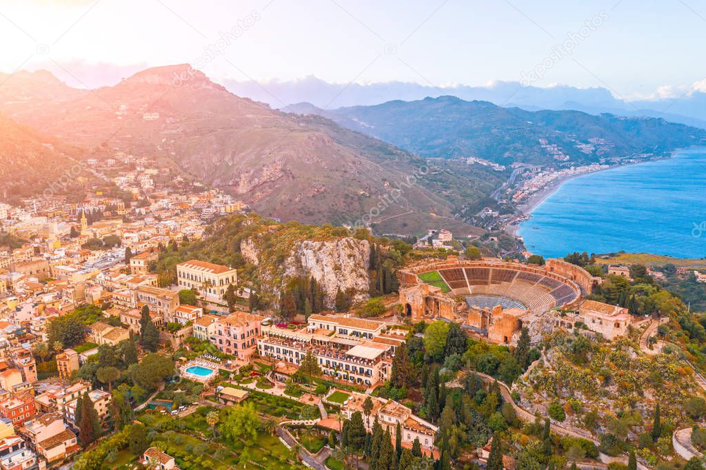 Taormina theater, amphitheater, arena is a town on the island of Sicily, Italy. Aerial view from above in the evening sunset.