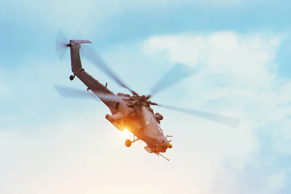 Military combat helicopter flies rapidly turning with a fire gun shot in the air. — Stock Photo, Image