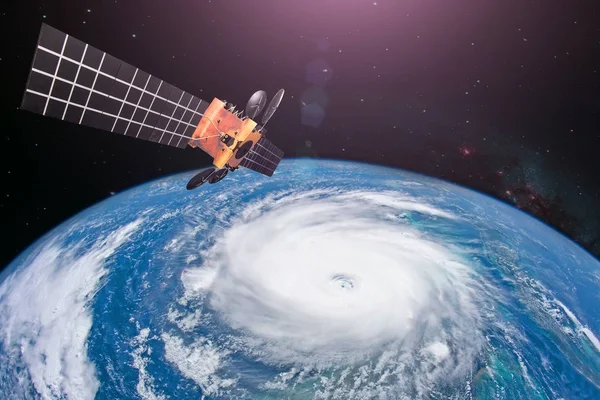 Monitoring hurricane. Satellite above the Earth makes measurements of the weather parameters and movement trajectory forecast. Elements of this image furnished by NASA.