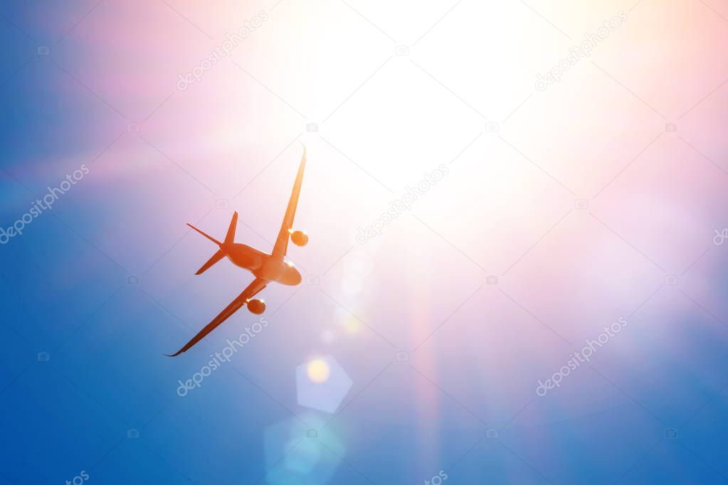 Bright sun in the sky and a flying passenger plane in height. The concept of tourism, vacation, travel.