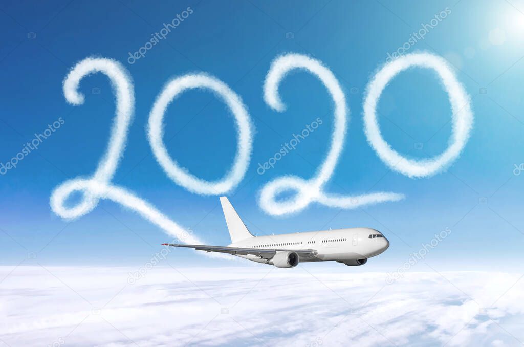 Happy New year 2020 concept travel. Drawing by passenger airplane vapor contrail in sky.
