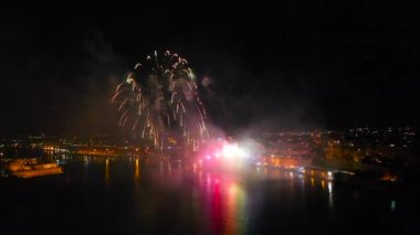 Gece körfezin üzerinde havai fişekler yüksekten havadan izleniyor.