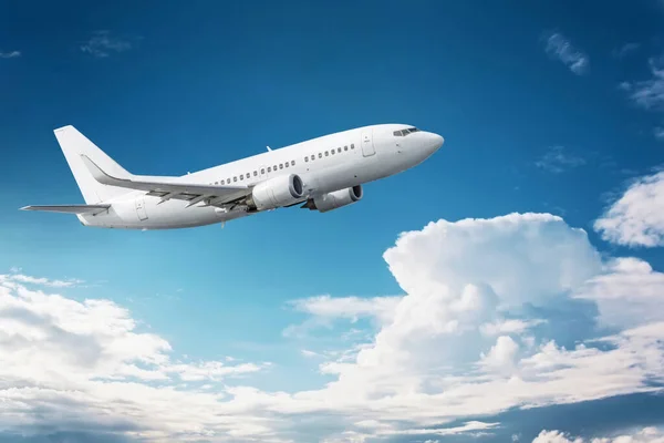 いくつかの雲と深い青の空に飛んで民間航空機 — ストック写真