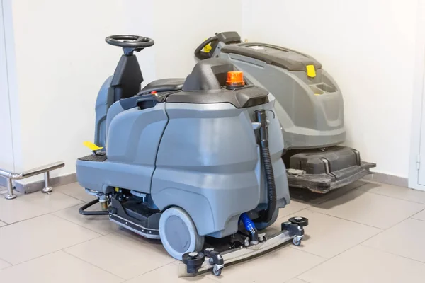 Floor care and cleaning services with professional washing machine on the charger machine inside public building