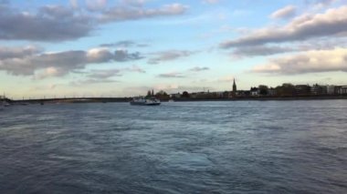 Bonn, Almanya - sakin Ren Nehri şehrin arka plan günbatımı zaman gemide ile  