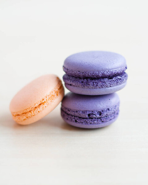 close-up photo of Colorful and sweet macaroons on white table