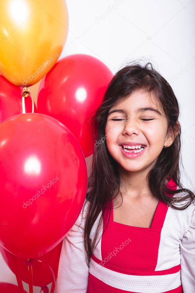 Baby Girl Holding Balloons celebrating her Birthday