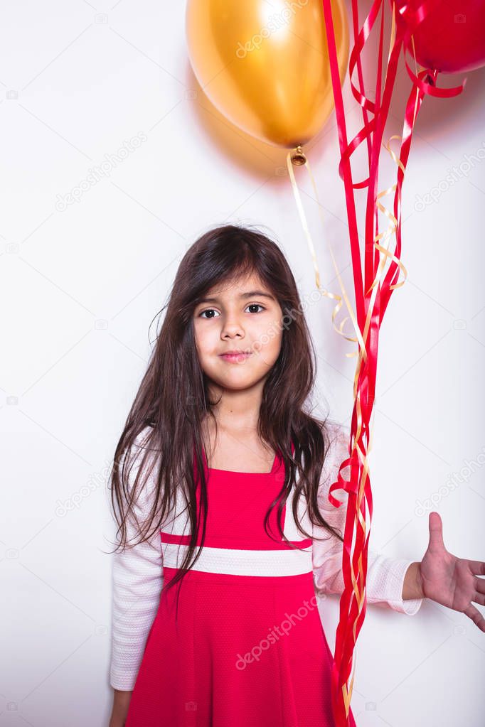 Baby Girl Holding Balloons celebrating her Birthda