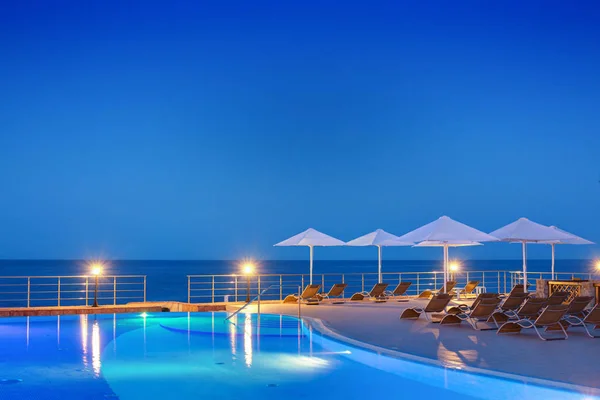 Swimming pool at night with a beautiful landscape