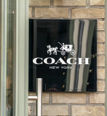 Ingolstadt, Germany : Shop front of Coach store. Coach, Inc. is known for accessories and gifts, including handbags, bags, small leather goods, footwear, outerwear and other accessories clipart