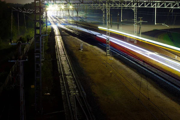 Tren gece raylar boyunca koşar. Fotoğraf Moskova 'da bir şehir caddesinde, 2018 sonbaharında, gökyüzünde, raylarda, trende çekildi. 