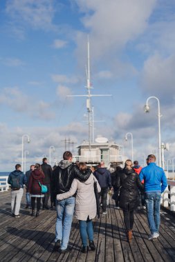 Sopot, Polonya - 6 Ekim 2019: Kucaklanan çiftler Polonya 'nın Sopot kentinde ana iskele boyunca yürüyorlar.
