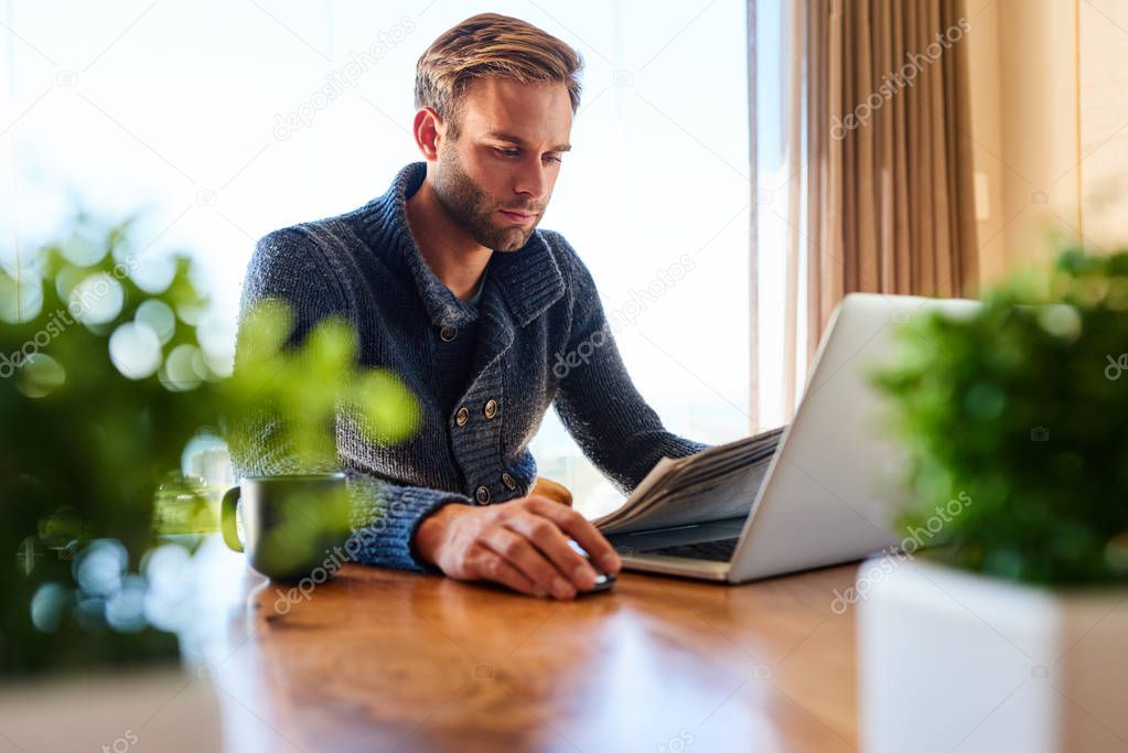 Modern trader working from home at his dining table