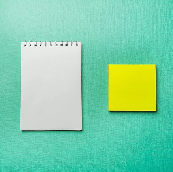 white blank notepad on green background