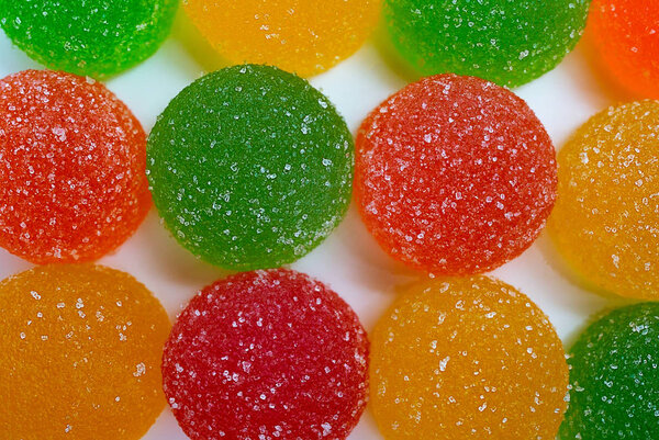 colored marmelades on white background