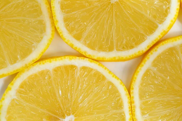 yellow slices of lemon on white background