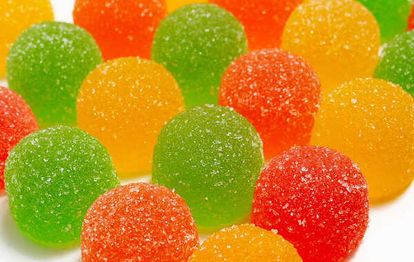 colored marmelades on white background