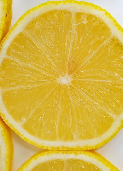 yellow slices of lemon on white background