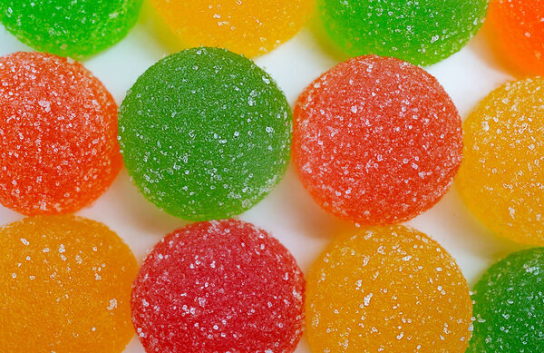 colored marmelades on white background